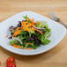 A plate of salad with Ken's Deluxe French Dressing on it.