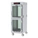 A large white holding cabinet with clear glass Dutch doors.