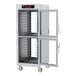 A large white metal Metro C5 holding cabinet with clear Dutch doors.
