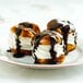 A close-up of three Rich's unfilled cream puff pastries with chocolate sauce.