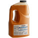 A gallon jug of Cattlemen's Carolina Tangy Gold BBQ Sauce with a yellow label.