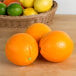 A case of fresh oranges on a table.