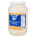 A Ken's Foods 1 gallon jar of honey mustard dressing on a counter.