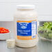 A jar of Ken's honey mustard dressing on a counter.
