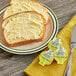 A plate with a piece of bread and a Smart Balance butter spread cup on it.