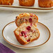 A cranberry walnut muffin made with Bake'n Joy Ultra Moist Muffin Mix on a plate.