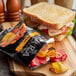 A sandwich with Terra Veggie Chips on a plate.