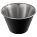 A matte black stainless steel round sauce cup with a silver rim.