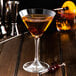 A martini glass of liquid with Fabbri Amarena cherries.