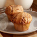 Two Bake'n Joy cinnamon coffee cake muffins on a plate.