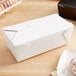 A white Fold-Pak Bio-Pak take-out box on a table.