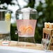 A Choice acrylic beverage dispenser filled with water, lemons, and oranges.