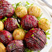 A plate of roasted red and green vegetables.