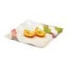 A white GET Contemporary Petite Square plate with two halves of oranges on it.