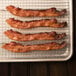 Kunzler thick sliced black pepper bacon on a metal rack.