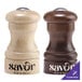 Two Chef Specialties customizable walnut pepper shakers on a table with a wooden salt shaker.