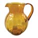 An amber plastic pitcher with a handle.