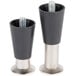 A pair of black metal Manitowoc refrigeration equipment legs with screws on them.