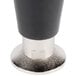 A close up of a set of black and metal Manitowoc refrigeration equipment legs.