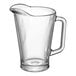 A clear glass pitcher with a handle.