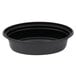 A close up of a black Pactiv VERSAtainer oval microwavable container with a black lid.