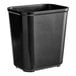 A black Rubbermaid rectangular fire-resistant plastic wastebasket.