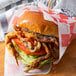 A sandwich with fried crab meat and lettuce and tomato.
