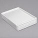 A stack of Channel white rectangular plastic platters.