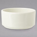 A white GET Ivory Melamine Ramekin on a gray surface.