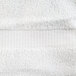 A close up of a white Oxford Belleeza bath towel with a striped surface.