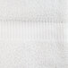 A close up of a white Oxford Belleeza bath towel with a stripe.