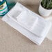 A stack of Oxford Platinum bath towels on a white counter.