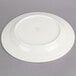 A white Oneida Espree china plate with green writing on it.
