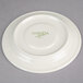 A white plate with a green logo on it.