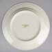 A white Oneida china plate with green writing on it.
