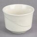 A close up of a Oneida cream white china bowl with a wavy design.