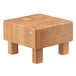 A Frilich beech wood cube display riser with legs.