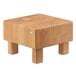 A wooden box with a square top on a table.