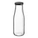 An Acopa clear glass milk bottle with a black lid.