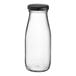 An Acopa clear glass milk bottle with a black lid.