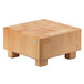 A Frilich beech wood butcher block cube riser with legs.