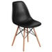 A black Flash Furniture Elon Series plastic side chair with wood legs.