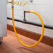 A yellow Regency gas connector hose attached to a black pipe.