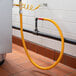 A yellow Regency gas connector hose attached to a pipe.