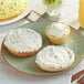 A plate with bagels and Scallion and Bacon Cream Cheese Spread on a table in a brunch cafe.