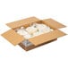 A cardboard box filled with plastic wrapped Mission 6" Pressed White Corn Tortillas.