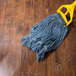 An Arm & Hammer yellow-handled mop on a wood floor.