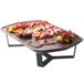 A Rosseto rectangular walnut melamine tray with meat and fruit on a table.