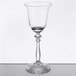 A clear glass wine glass with a stem.