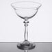 A clear Libbey coupe cocktail glass with a stem.